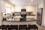 Open Concept Custom Kitchen with Granite Countertops
and Stainless Steel Appliances