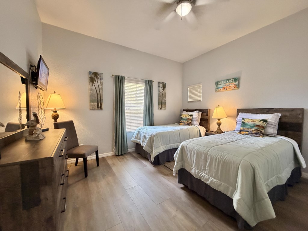 Cozy twin bedroom designed for comfort and convenience with Smart TV.
