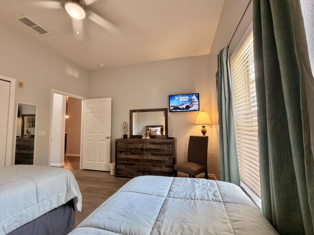 Cozy twin bedroom designed for comfort and convenience with Smart TV.