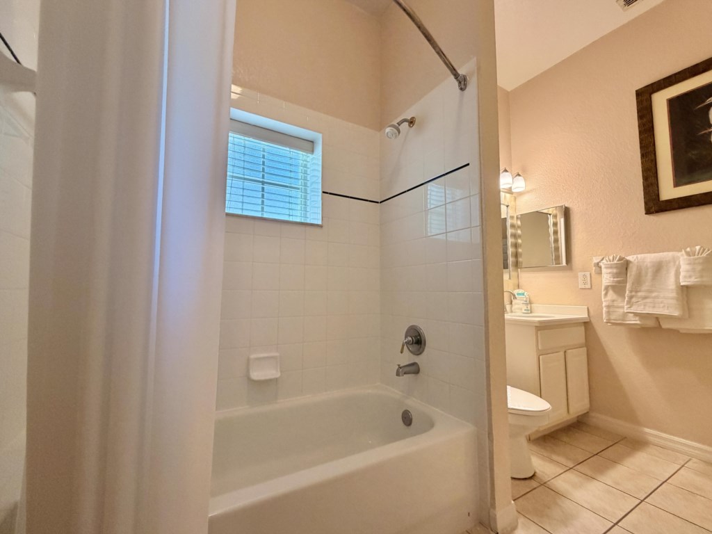Bright guest bathroom with fresh towels provided.
