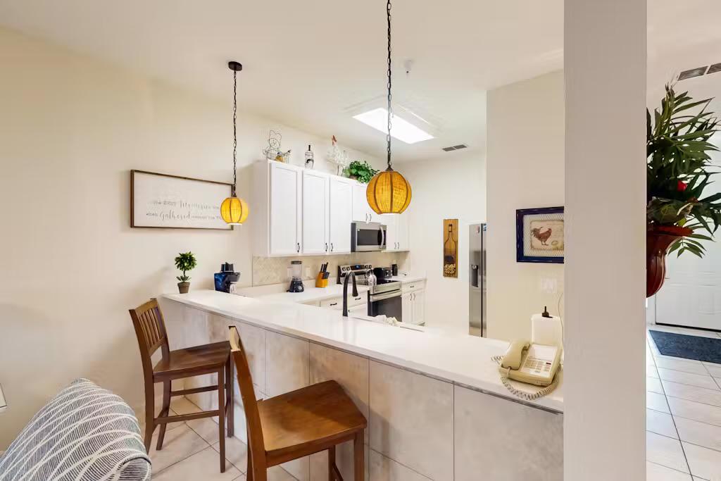 Kitchen counter with bar stools—perfect for enjoying a drink or breakfast in a warm and inviting setting.