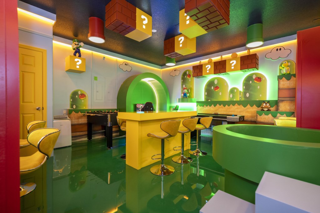 Mario Bros themed game room w/ arcade, Xbox, foosball.