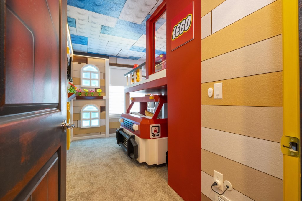 Lego Themed bedroom w/ slide to the loft, flat screen TV & bunk bed full over full