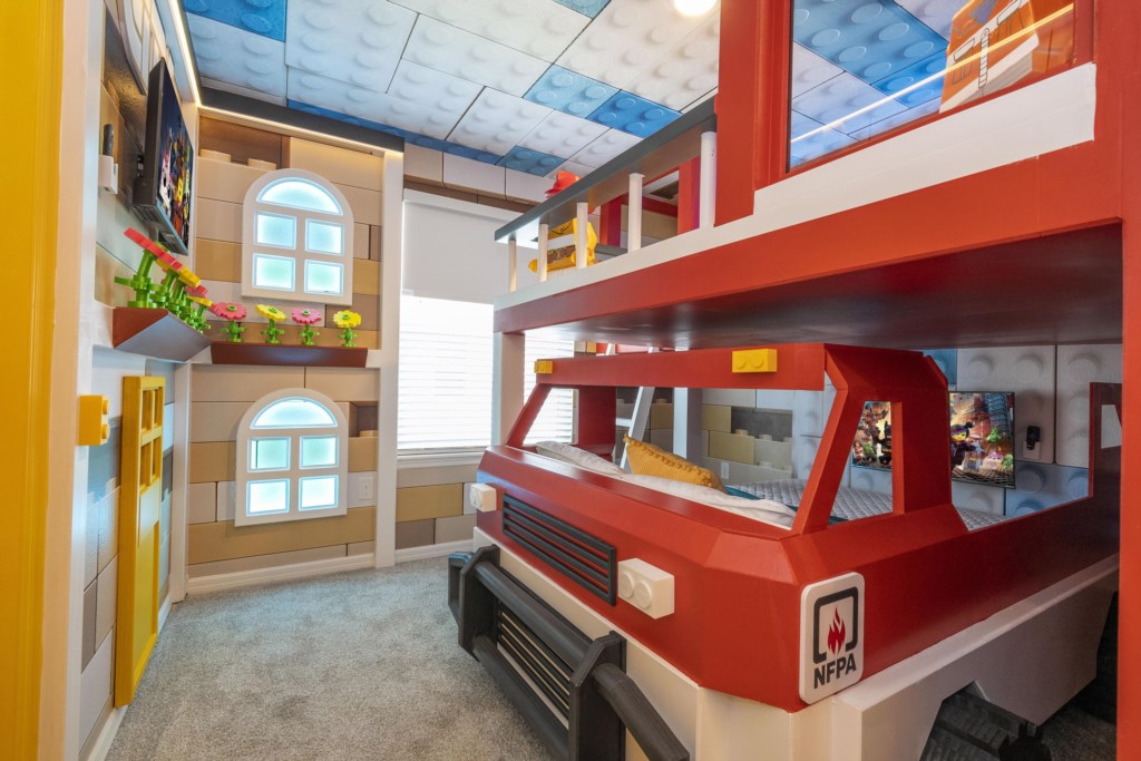 Lego Themed bedroom w/ slide to the loft, flat screen TV & bunk bed full over full