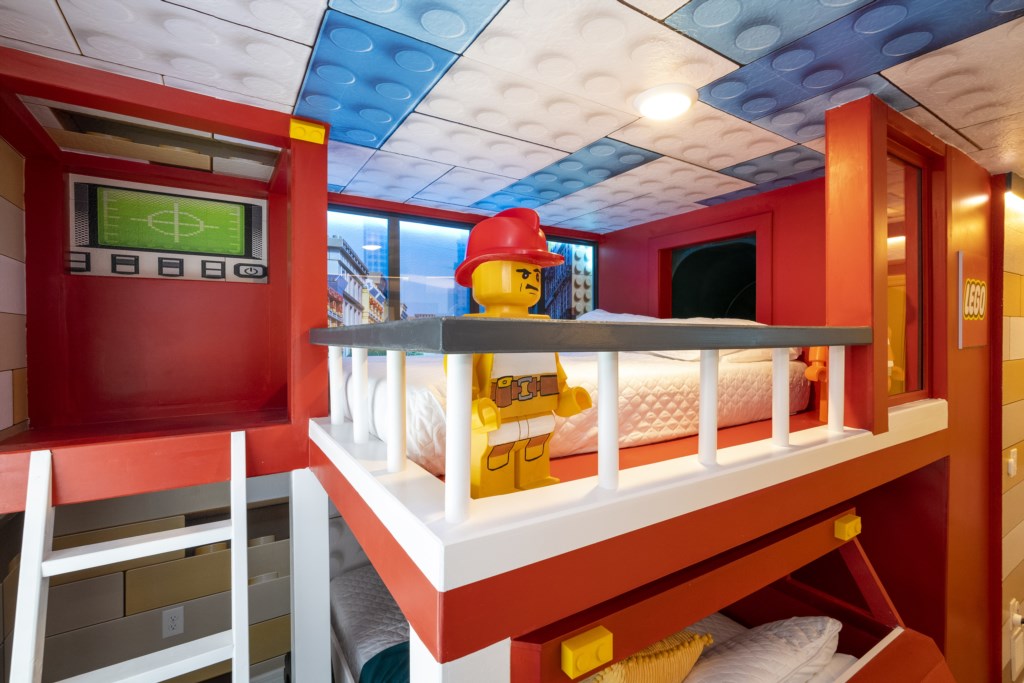 Lego Themed bedroom w/ slide to the loft, flat screen TV & bunk bed full over full