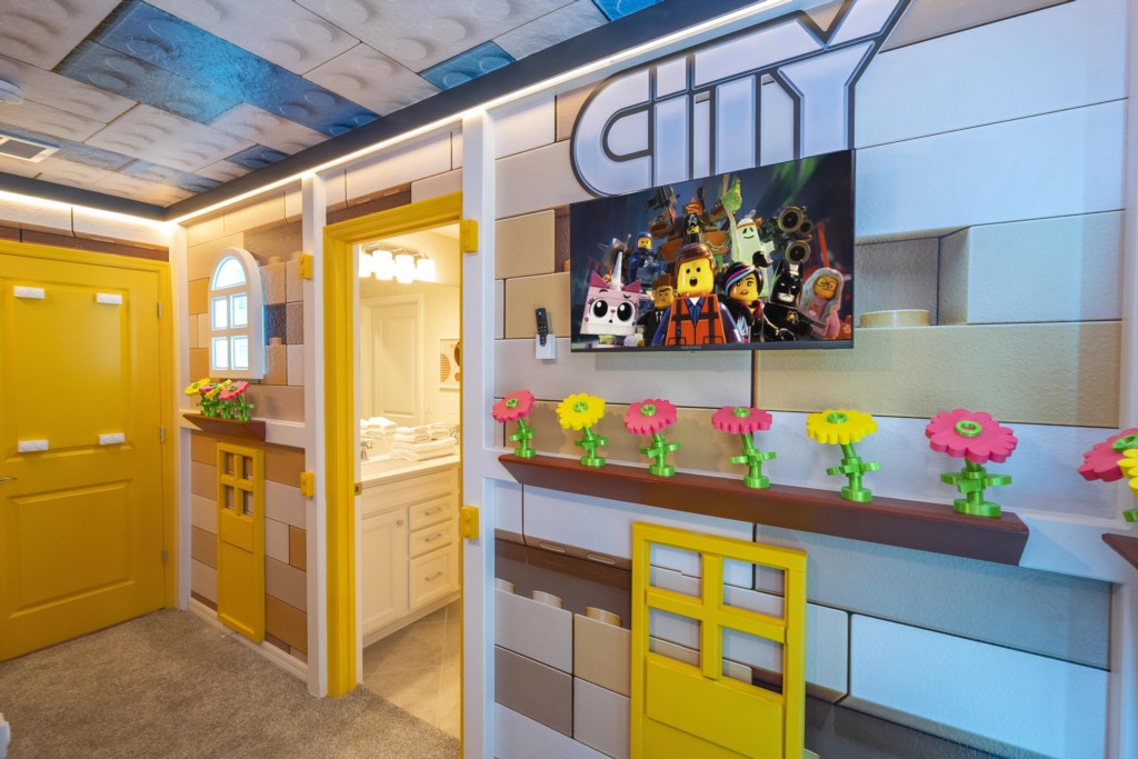 Lego Themed bedroom w/ slide to the loft, flat screen TV & bunk bed full over full