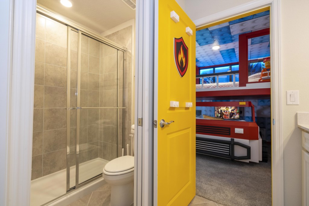 Lego Themed bedroom w/ slide to the loft, flat screen TV & bunk bed full over full