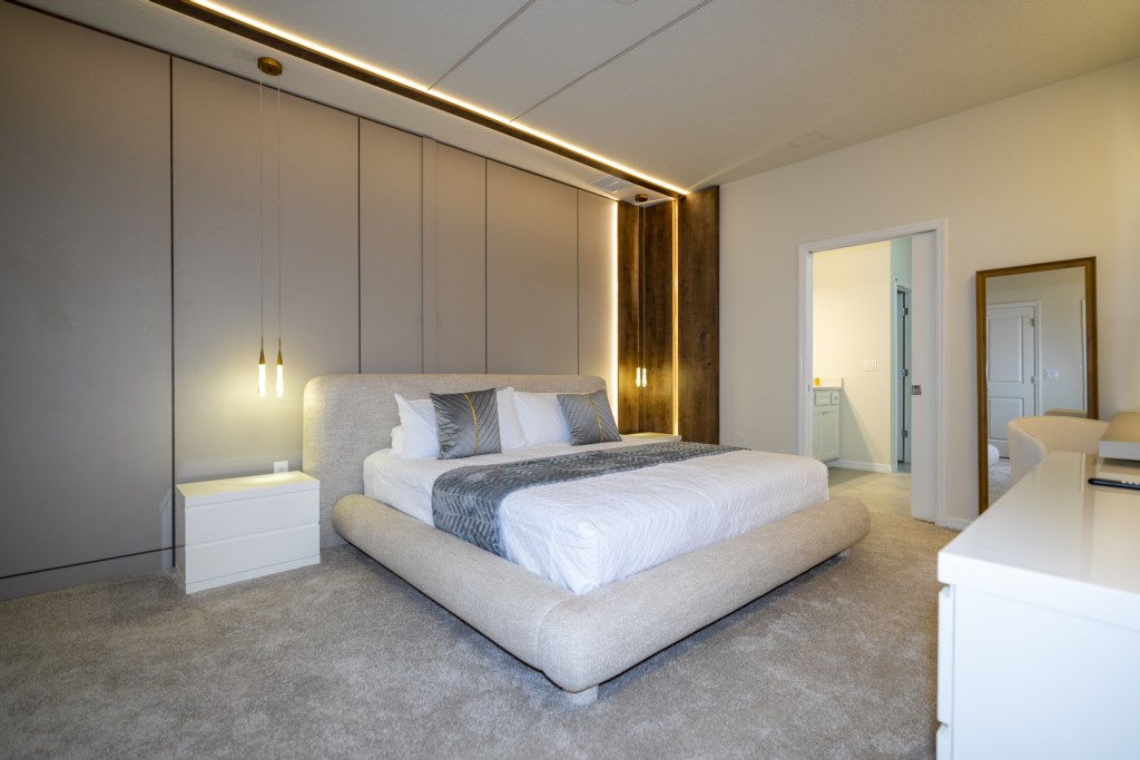 Master bedroom 1st floor w/ king size bed, TV and private bathroom