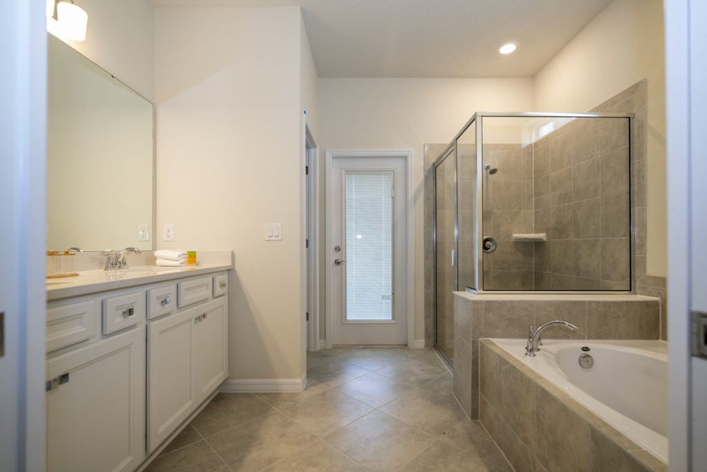 Master bedroom 1st floor w/ king size bed, TV and private bathroom