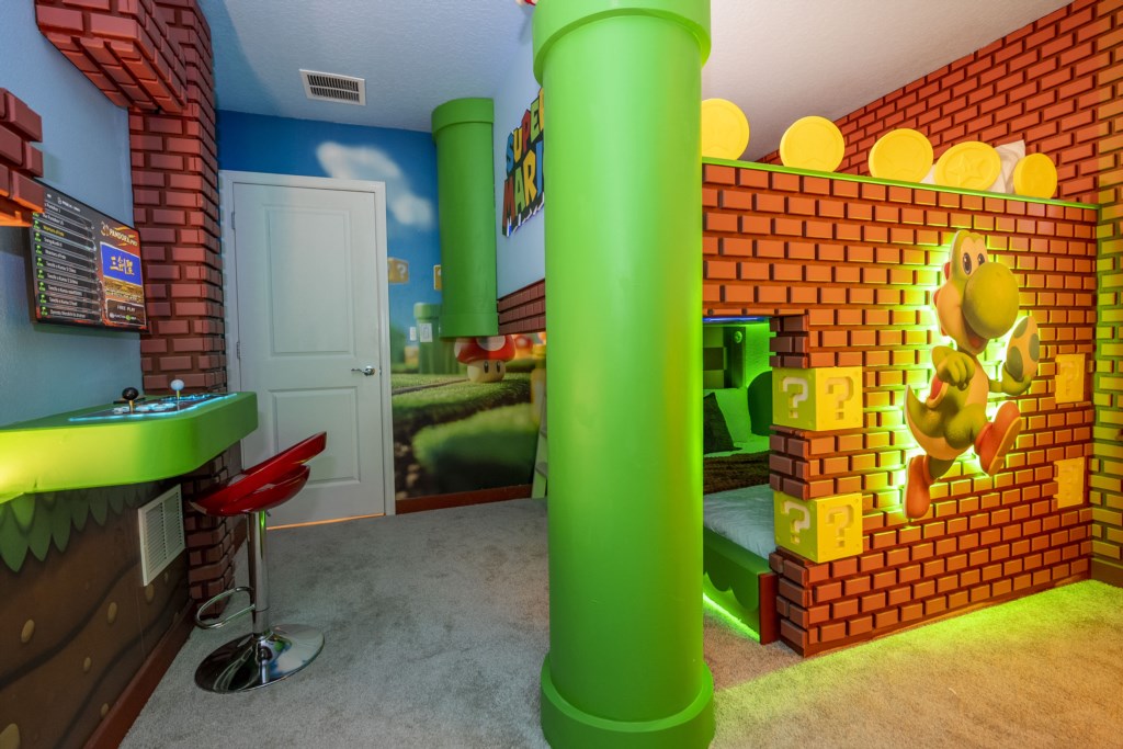 Super Mario Themed bedroom w/ TV and full over full beds.