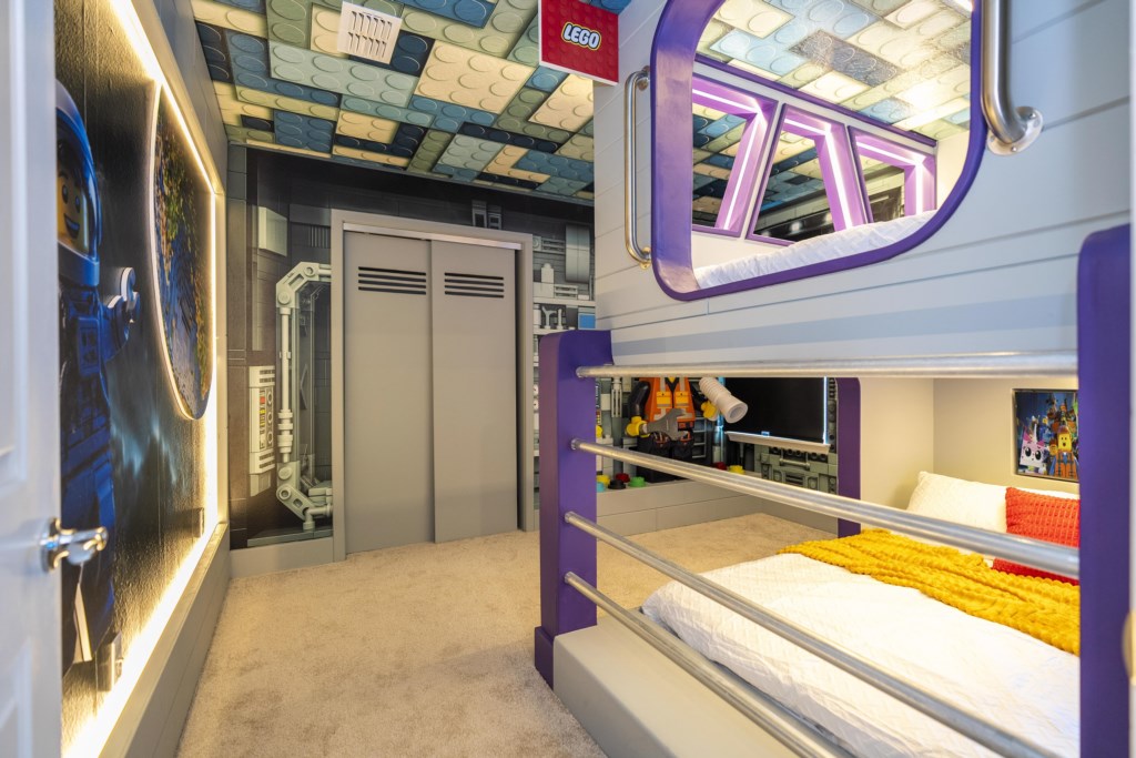 LEGO Themed bedroom w/ TV and full over full beds.