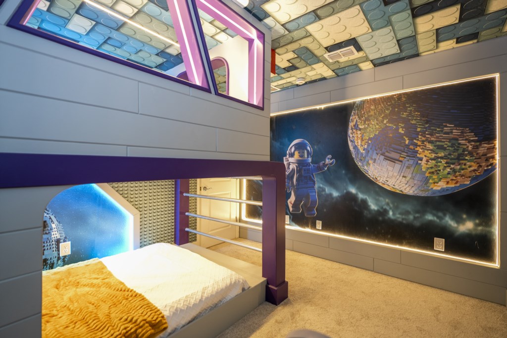 LEGO Themed bedroom w/ TV and full over full beds.
