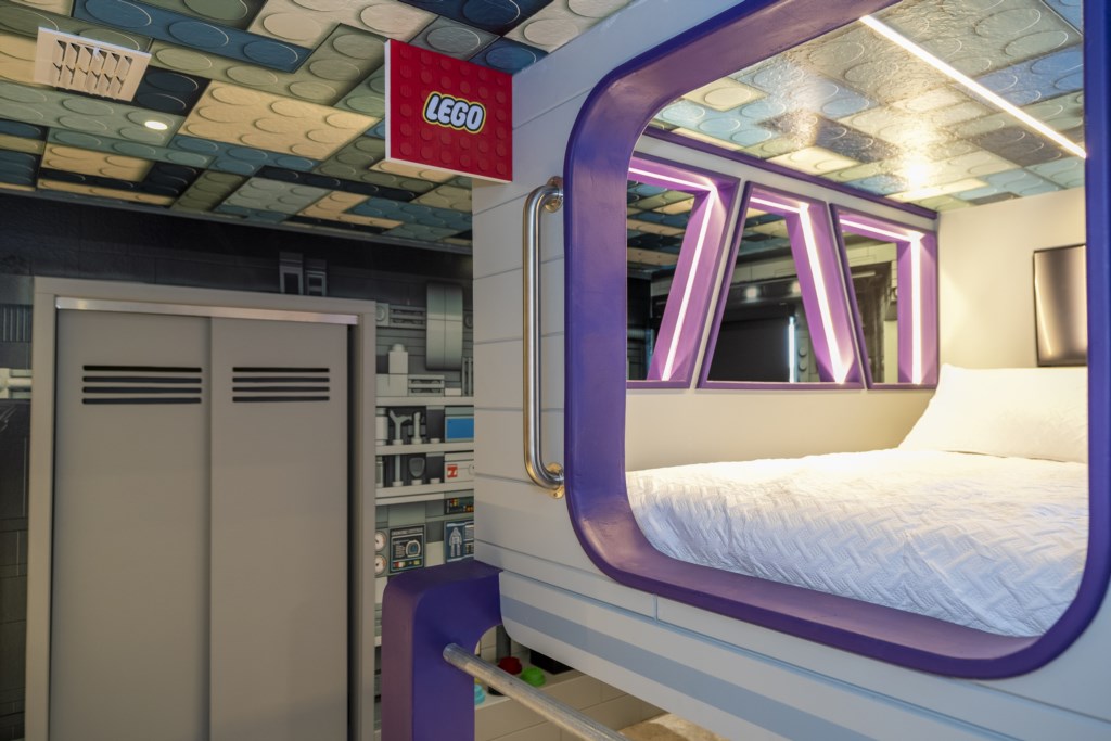 LEGO Themed bedroom w/ TV and full over full beds.