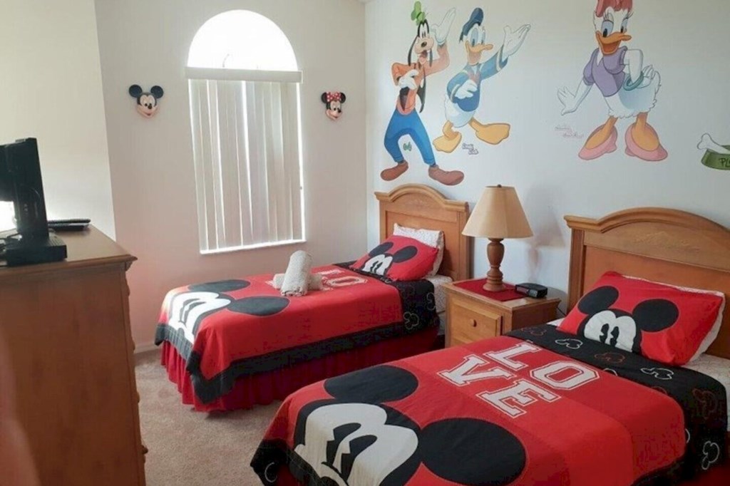 This charming Disney-themed twin bedroom is located on the first floor and has a walk in closet for your convenience
