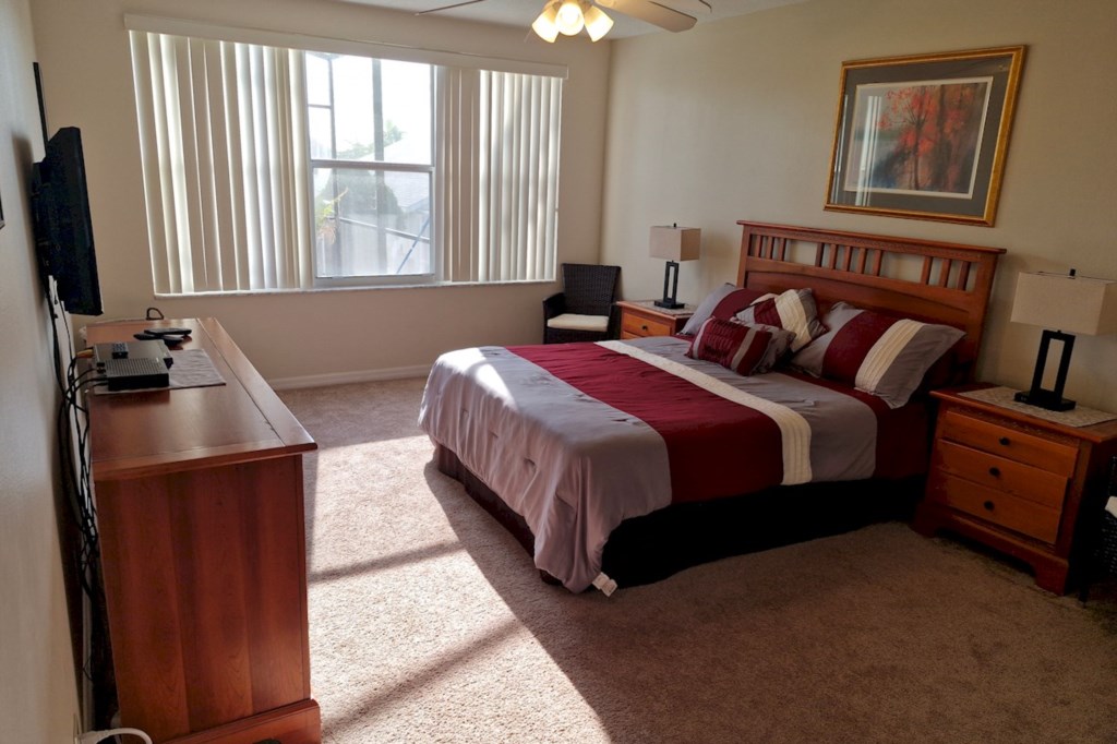 Downstairs Master suite featuring a private view of the swimming pool area.