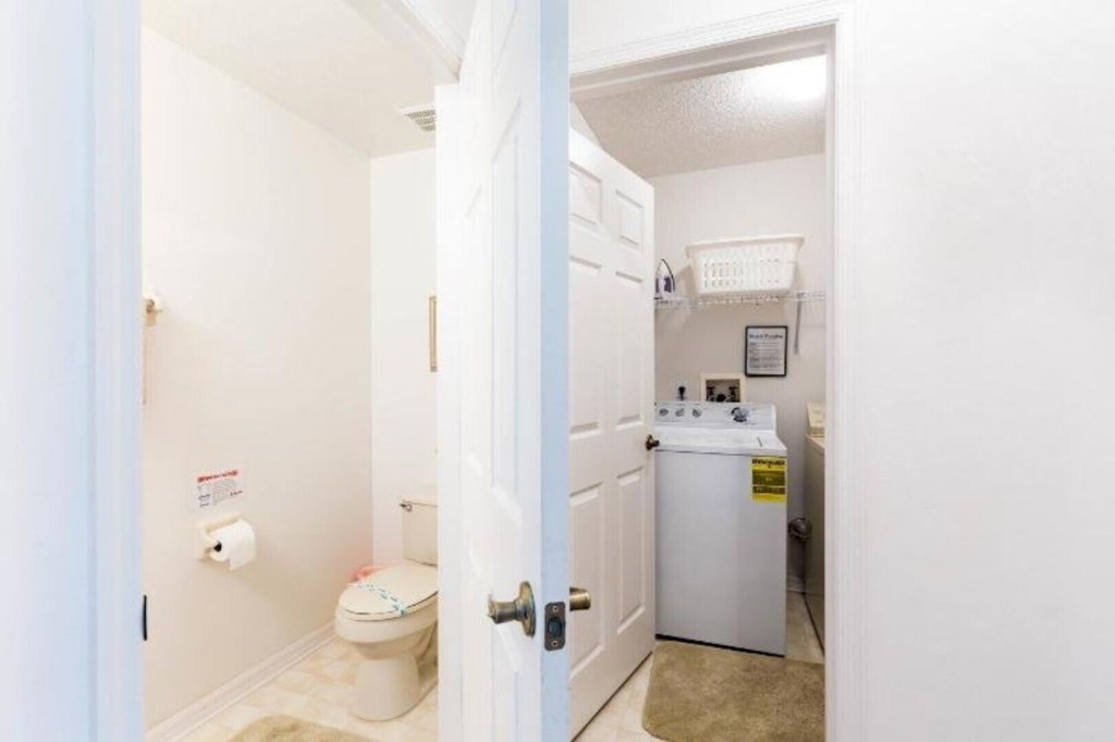 Convenient ground-floor laundry room and guest bathroom for easy accessibility.