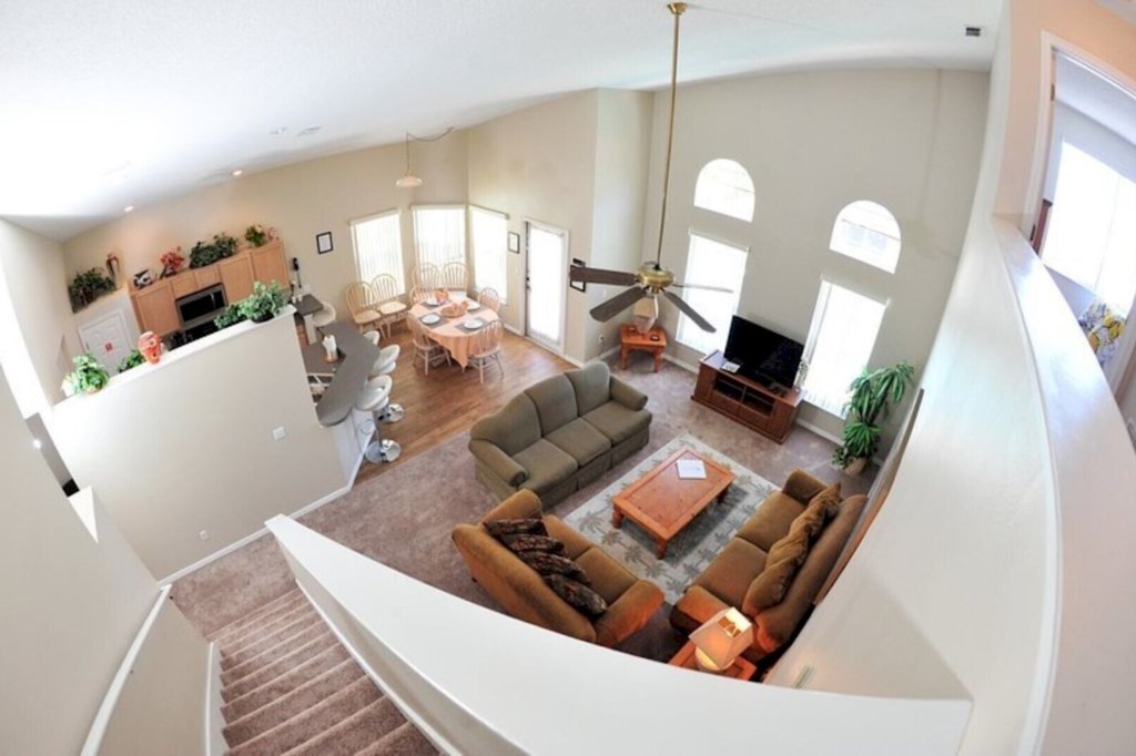 Spacious living room featuring comfortable seating, modern decor, and abundant natural light, perfect for relaxing