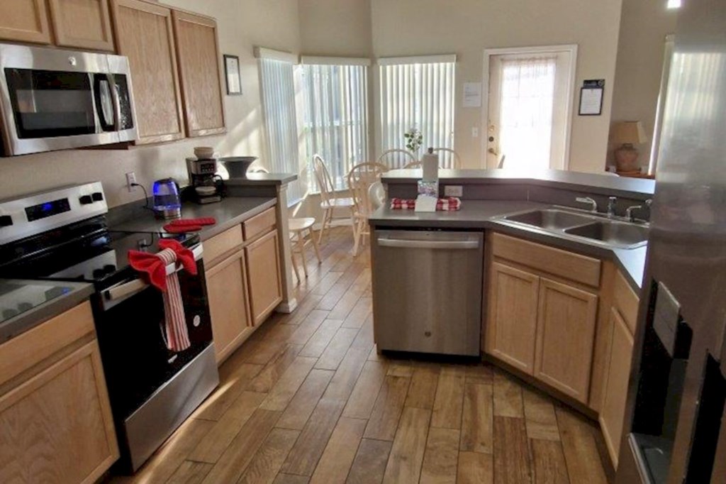 Modern, fully-equipped kitchen featuring premium stainless steel appliances