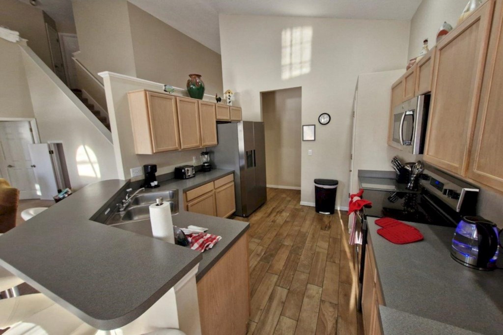 This fully equipped kitchen features modern appliances, ample counter space
