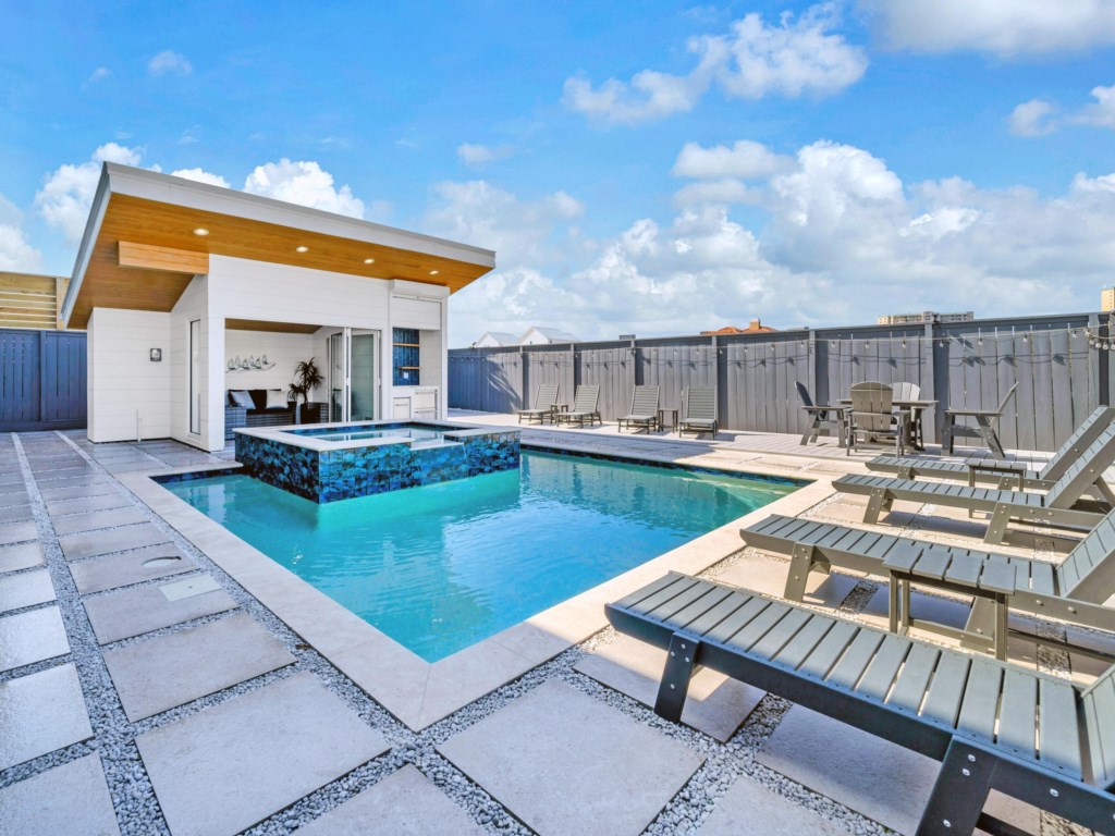 Relaxing private pool area with ample sun loungers and a shaded seating, ideal for cooling off or soaking up the sun.