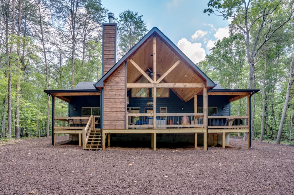 Charming cabin retreat with spacious deck, surrounded by serene forest views.