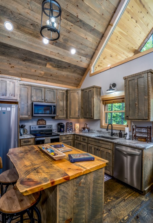 Rustic kitchen with vaulted ceiling and modern amenities for a cozy cooking experience.