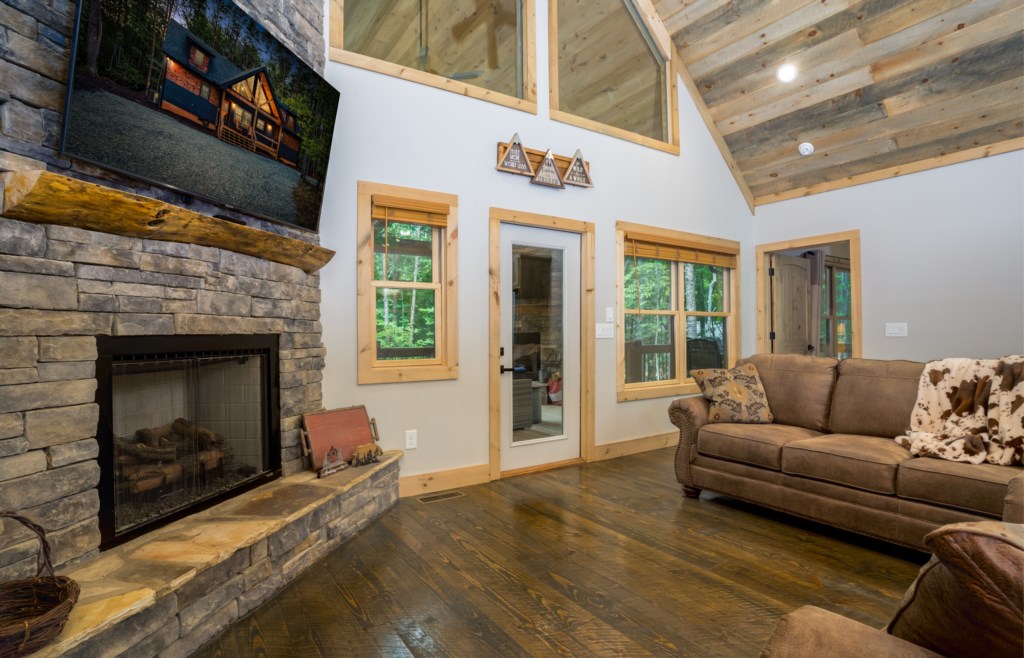 Rustic living room with stone fireplace and cozy seating, perfect for relaxing after a day of adventure.