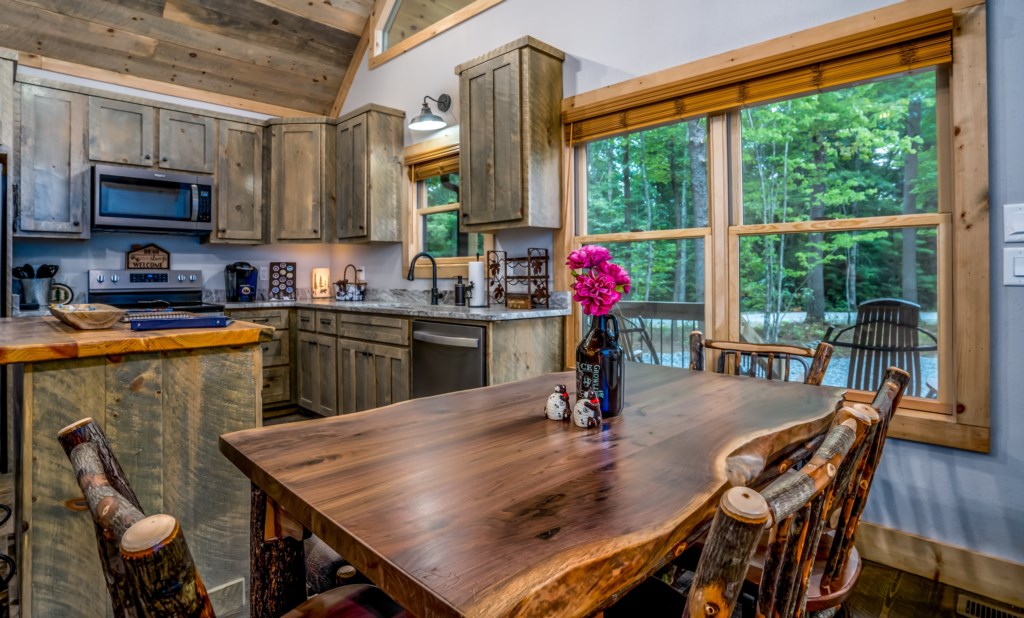 Rustic kitchen with natural wood finishes and forest views, perfect for cozy family meals.