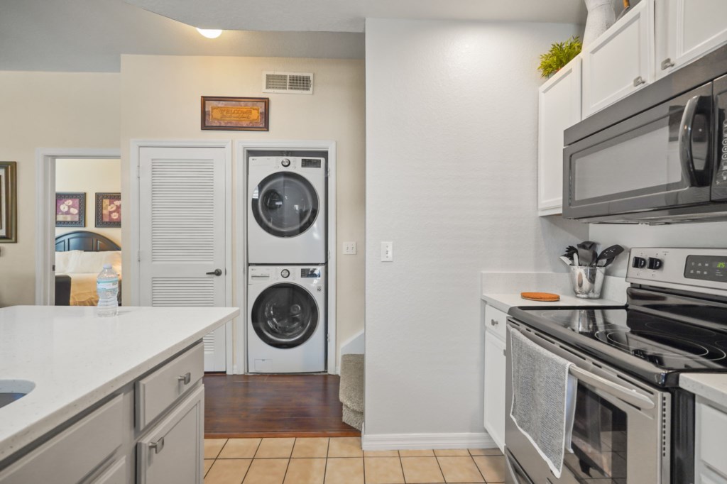 Kitchen area with laundry area & King bedroom # 1 in background.