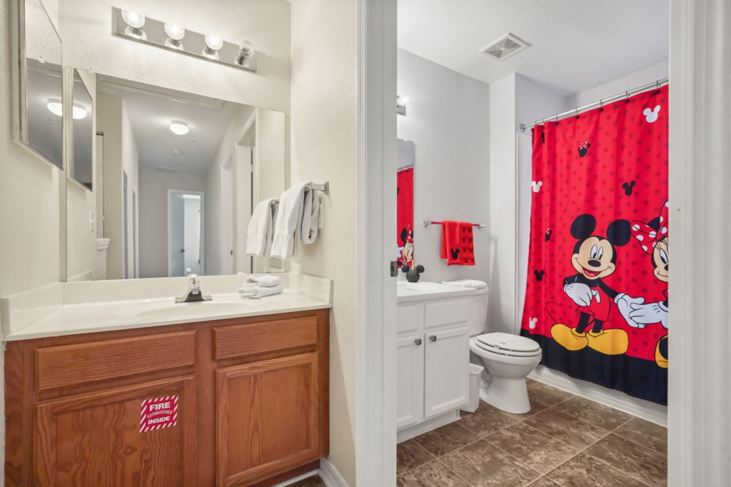 Bathroom # 3 upstairs shared with Bedrooms 3 & 4 with toilet, sink, & tub/shower combo Mickey & Minnie Themed.