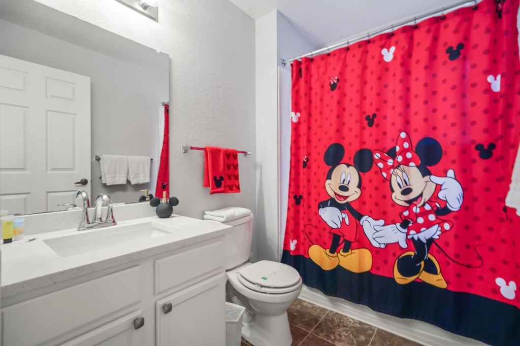 Bathroom # 3 upstairs shared with Bedrooms 3 & 4 with toilet, sink, & tub/shower combo Mickey & Minnie Themed.