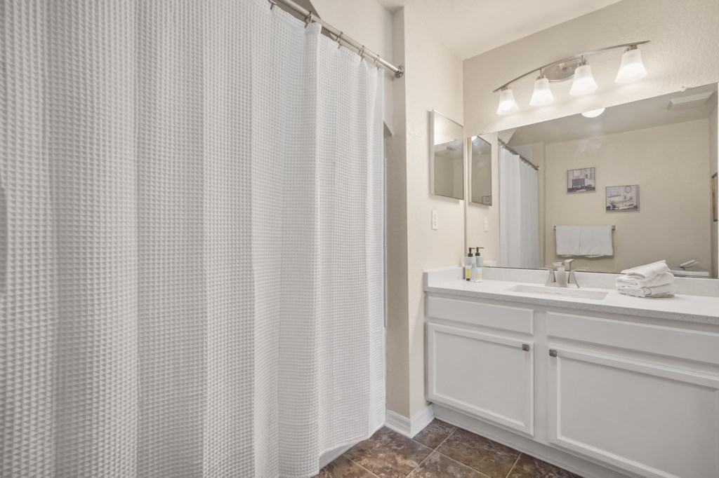 Bathroom # 2 upstairs en-suite to bedroom # 2 with sink, toilet, & tub/shower combo.