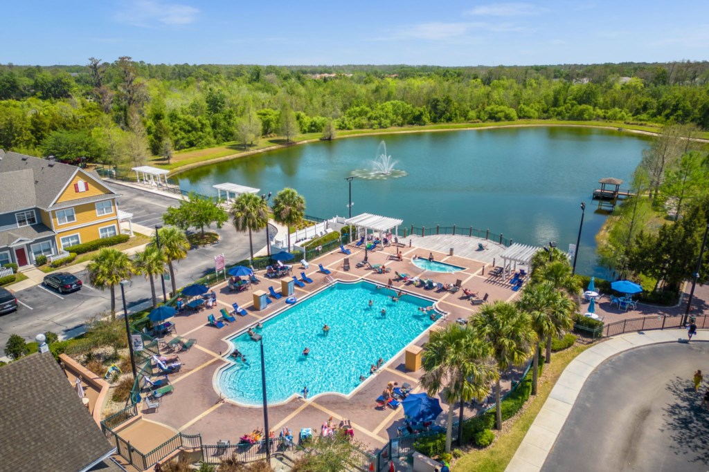 Overview of the resort pool area for guest use with the lake in the background.