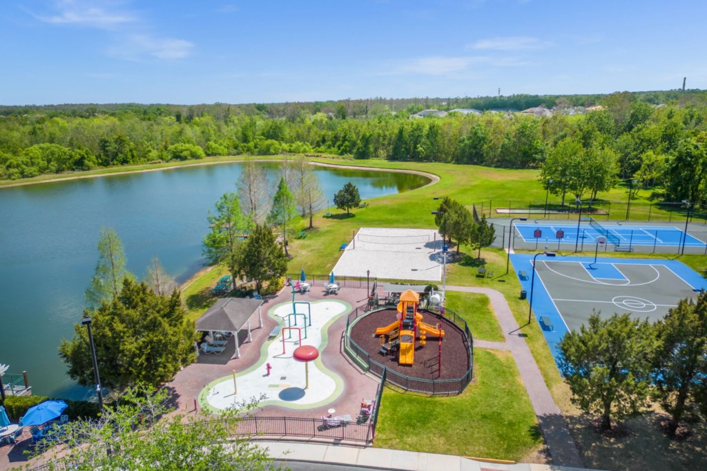 Overview of the resort community kids playground area with sand volleyball in background.