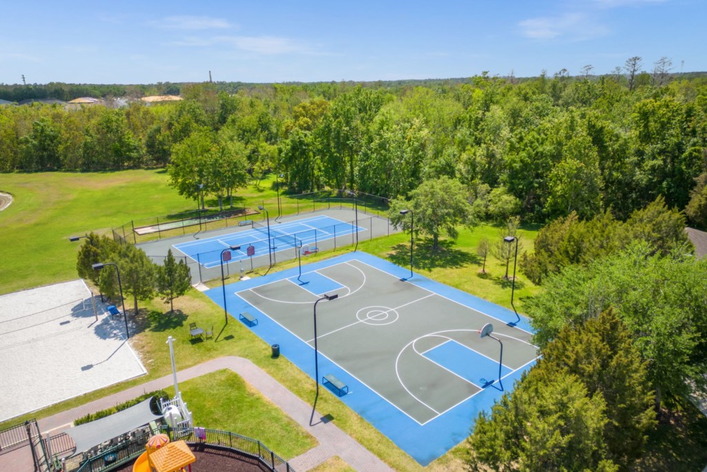Overview of the resort community basketball and tennis court for guest use.