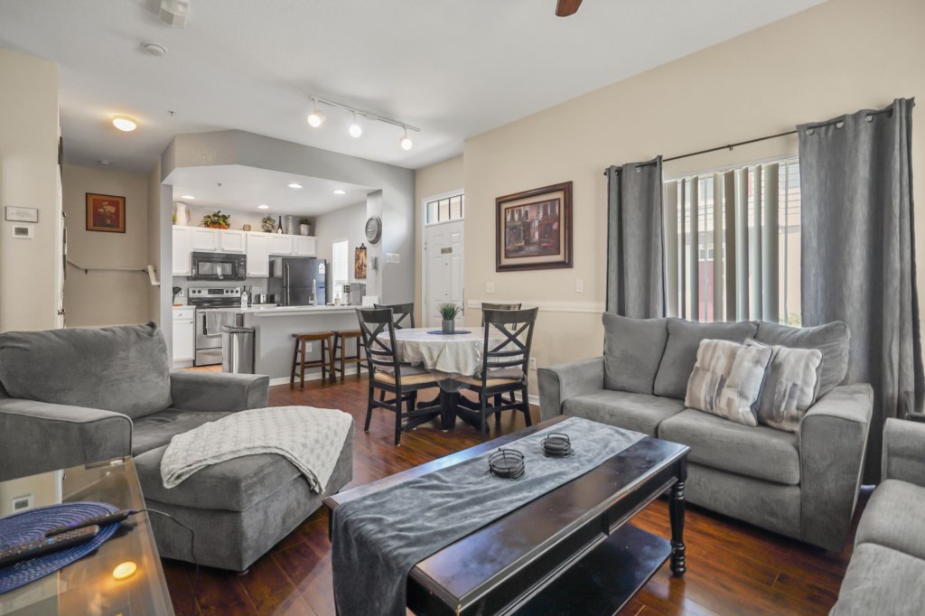 Living room area with dining area that seats 4 people & breakfast bar for 2 people with the kitchen area in the back,