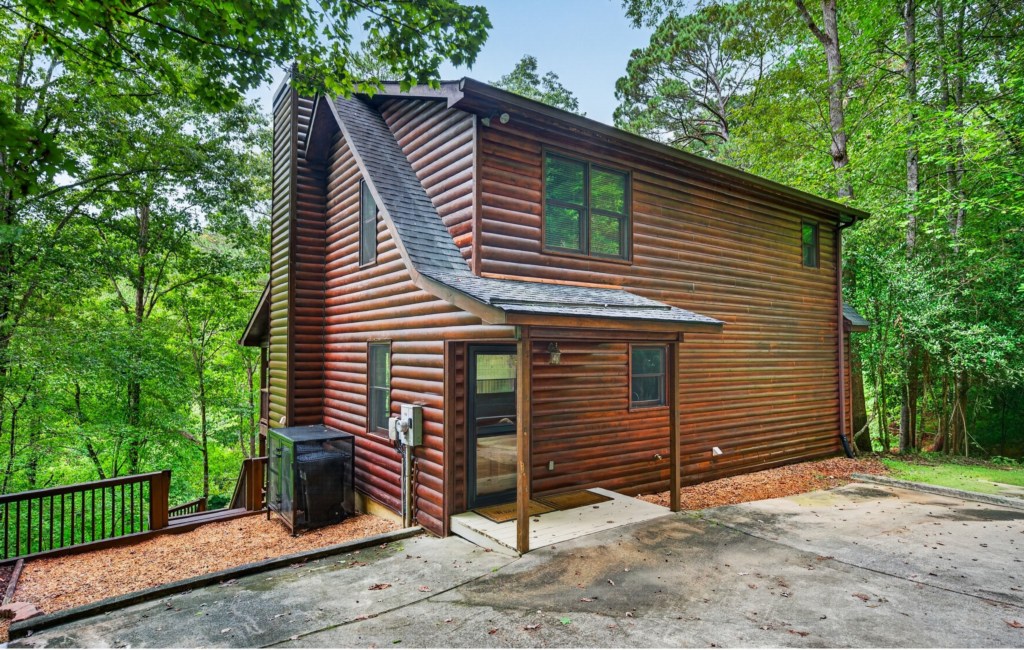 Charming log cabin nestled in lush forest, perfect for a tranquil retreat.