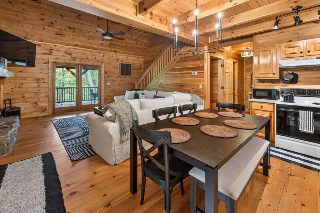 Cozy open-plan living area with rustic wood accents and modern kitchen amenities.