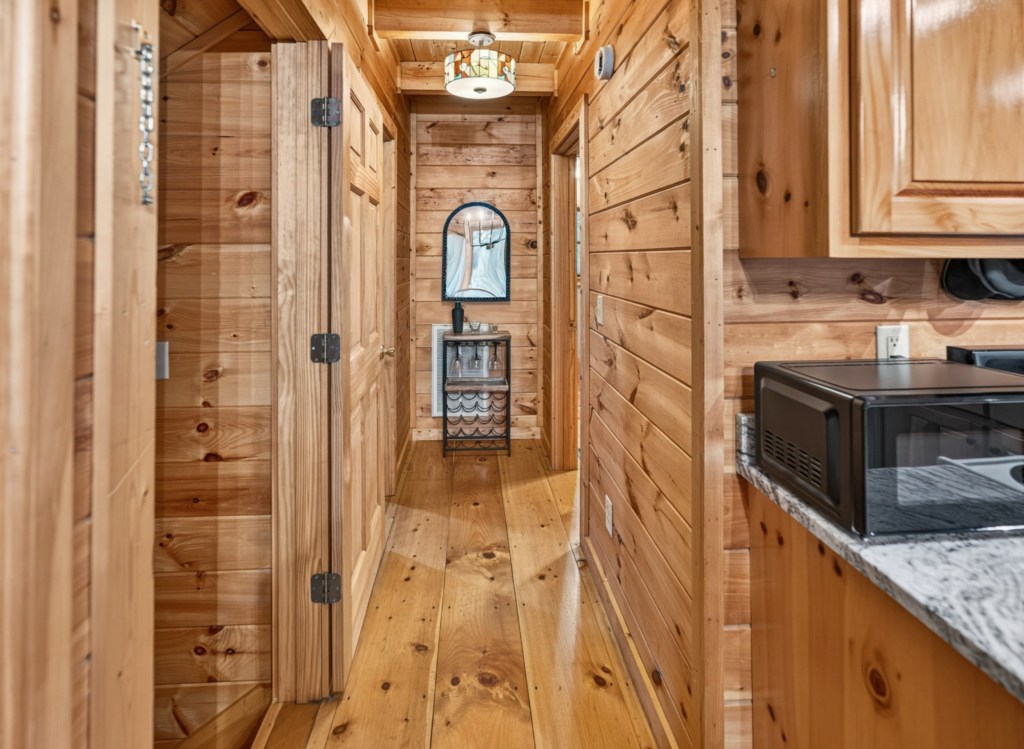 Rustic wood-paneled hallway with cozy cabin ambiance and modern amenities.