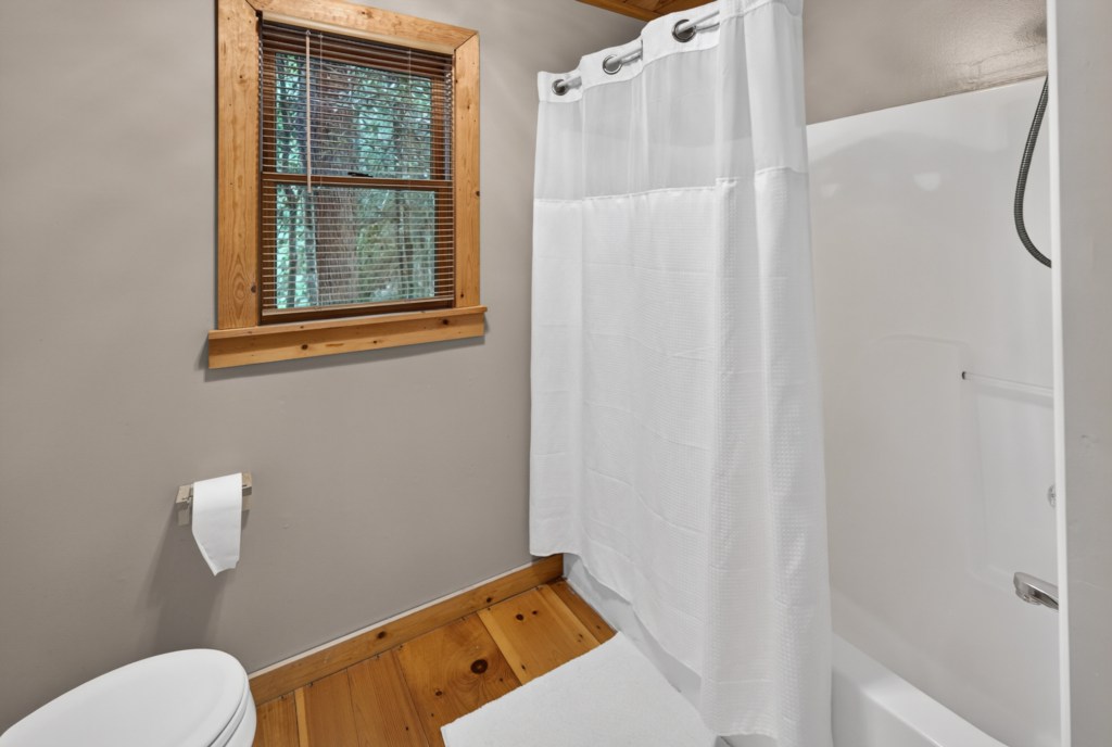 Charming bathroom with rustic wood accents and natural light.