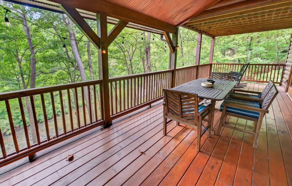 Spacious deck with forest views, perfect for outdoor dining and relaxation.