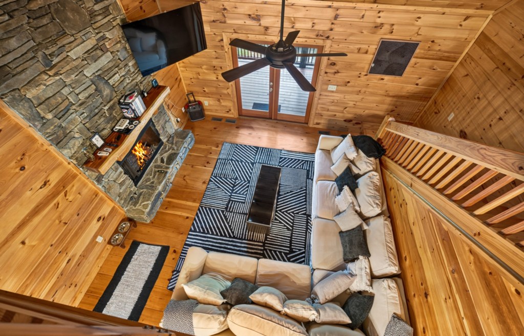 Cozy living room with rustic stone fireplace and plush sectional sofa for ultimate relaxation.