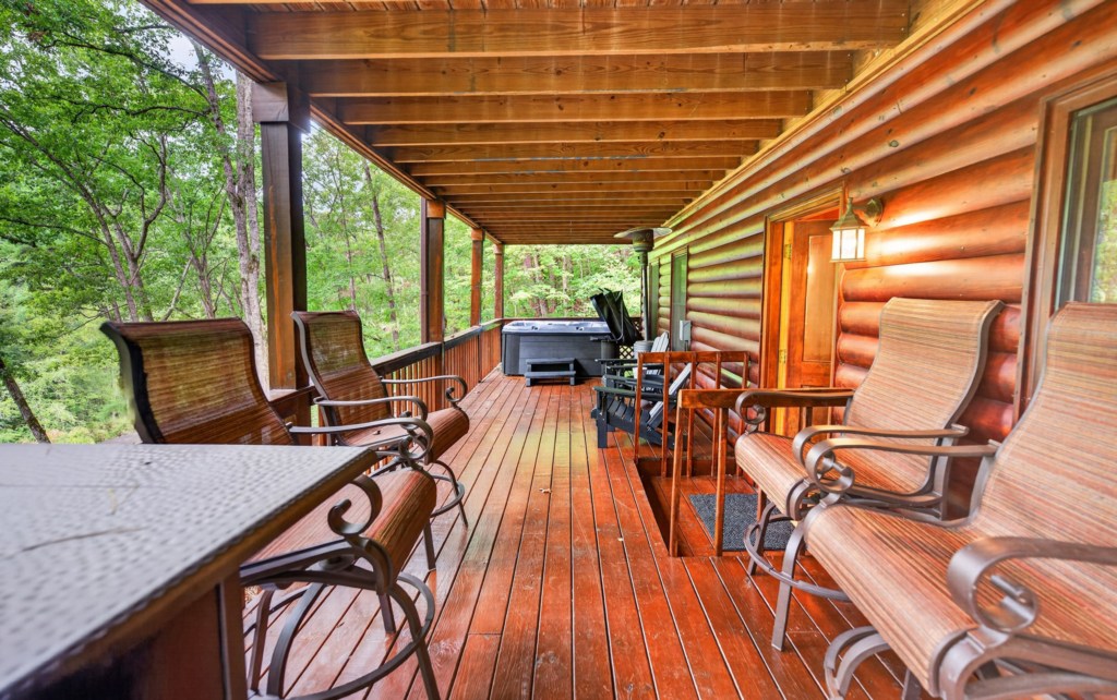 Relax on the spacious deck with forest views and a private hot tub.