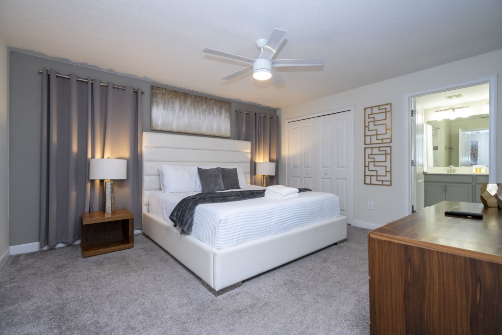 Master suite with a king size bed and TV