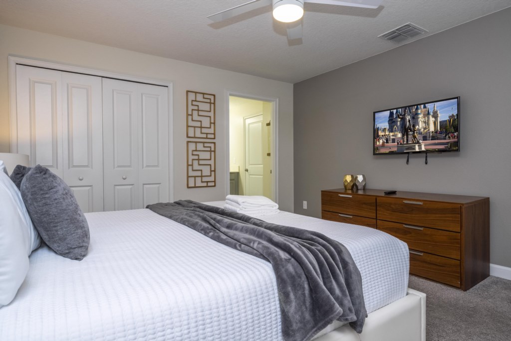 Master suite with a king size bed and TV