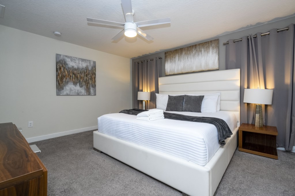 Master suite with a king size bed and TV