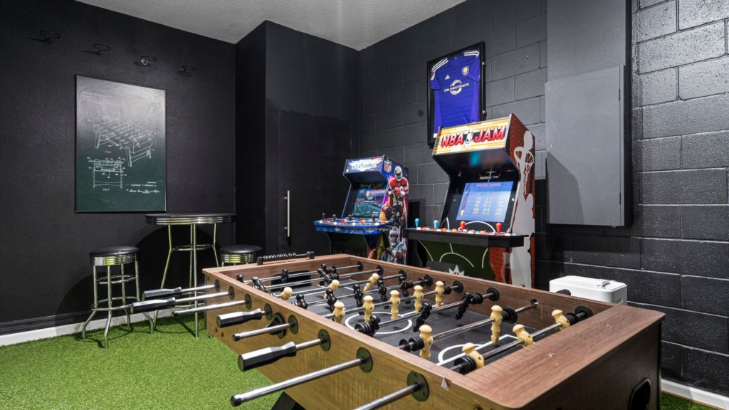 Game room w/ foosball, arcade and air hockey table.