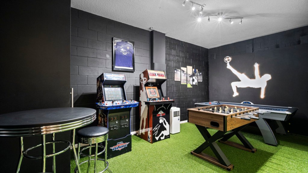 Game room w/ foosball, arcade and air hockey table.