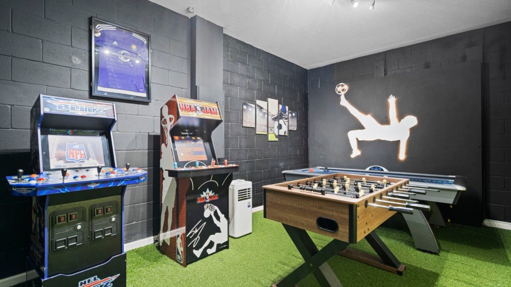 Game room w/ foosball, arcade and air hockey table.
