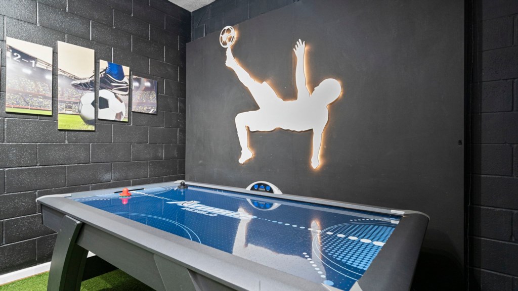 Game room w/ foosball, arcade and air hockey table.